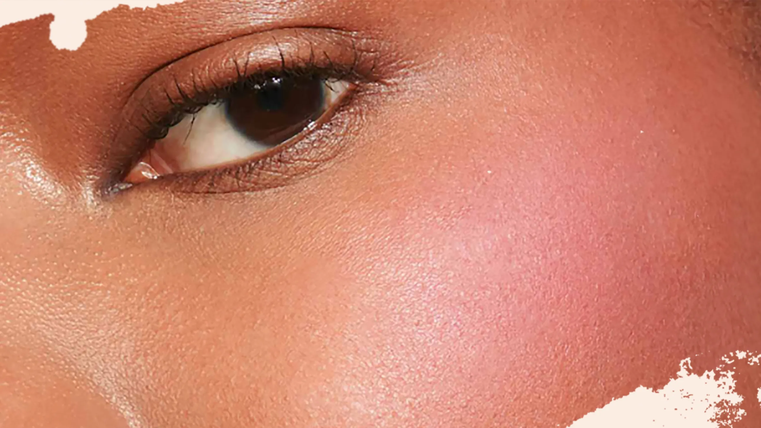A makeup artist applying powder blush to create rosy cheeks