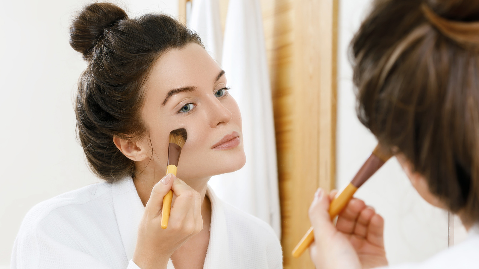 A makeup artist applying a soft contour to create a winter makeup look