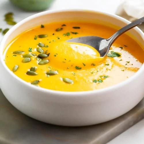 A bowl of roasted butternut squash soup with vegetables