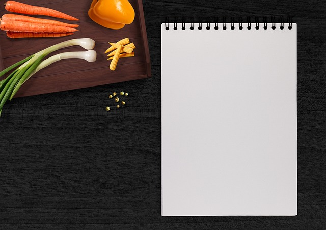 writing pad, vegetables, table